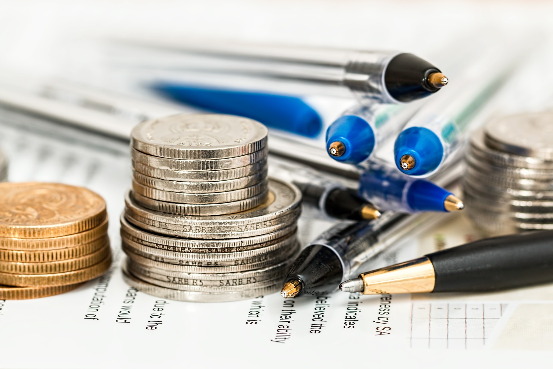 Premium Photo  Pen and coins on the tax form